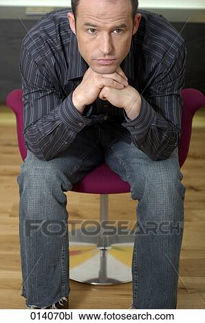 portrait of serious man sitting on lounge chair View Large Photo Image Stock Image - portrait of serious man sitting on lounge chair. Fotosearch