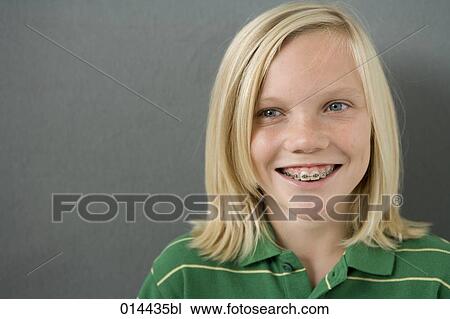 Stock Image - portrait of smiling teenage boy with braces. Fotosearch