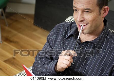 portrait of smiling young businessman with pen and diary View Large Photo Image Stock Image - portrait of smiling young businessman with pen and diary. Fotosearch