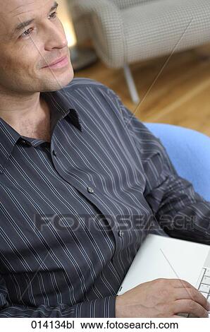 portrait of smiling young businessman with notebook computer thinking View Large Photo Image Stock Image - portrait of smiling young businessman with notebook computer thinking. Fotosearch