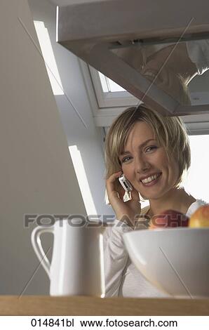 portrait of smiling young woman with cellphone in kitchen View Large Photo Image Stock Image - portrait of smiling young woman with cellphone in kitchen. Fotosearch