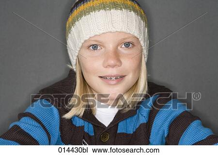 Stock Image - portrait of teenage boy indoors in winter clothes. Fotosearch