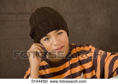 Stock Image - portrait of teenage boy with earphones listening to music. Fotosearch
