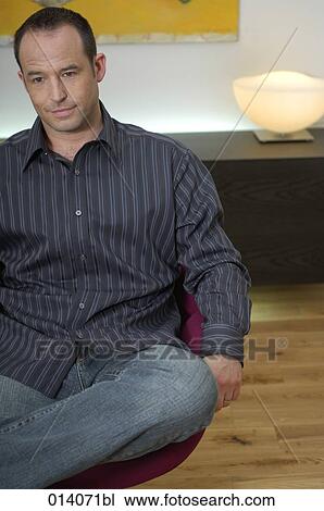 portrait of thoughtful man sitting on lounge chair View Large Photo Image Stock Image - portrait of thoughtful man sitting on lounge chair. Fotosearch