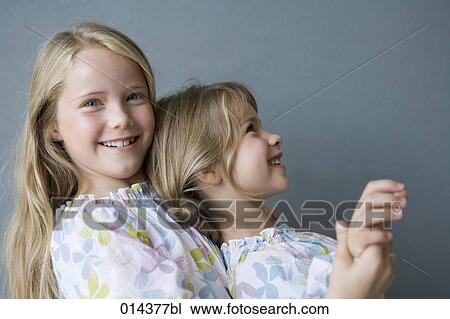 portrait of two sisters hugging View Large Photo Image Stock Image - portrait of two sisters hugging. Fotosearch