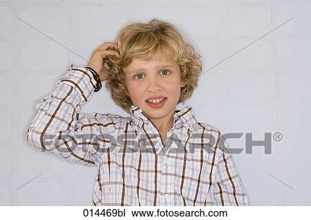 portrait of young boy scratching his head View Large Photo Image Stock Image - portrait of young boy scratching his head. Fotosearch
