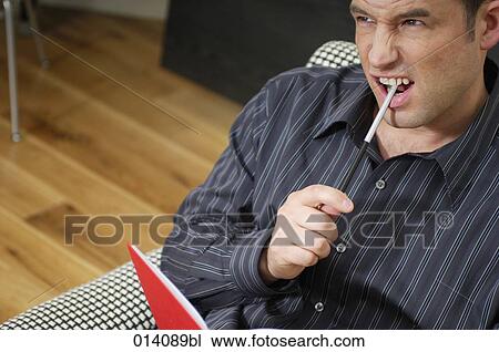 portrait of young businessman with pen and journal thinking View Large Photo Image Stock Image - portrait of young businessman with pen and journal thinking. Fotosearch