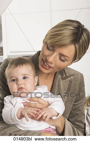 portrait of young businesswoman holding her little baby daughter View Large Photo Image Stock Image - portrait of young businesswoman holding her little baby daughter. Fotosearch
