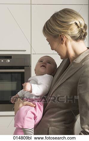 portrait of young businesswoman smiling at her little baby daughter View Large Photo Image Stock Image - portrait of young businesswoman smiling at her little baby daughter. Fotosearch