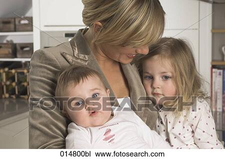 portrait of young businesswoman cuddling her little daughters View Large Photo Image Stock Image - portrait of young businesswoman cuddling her little daughters. Fotosearch