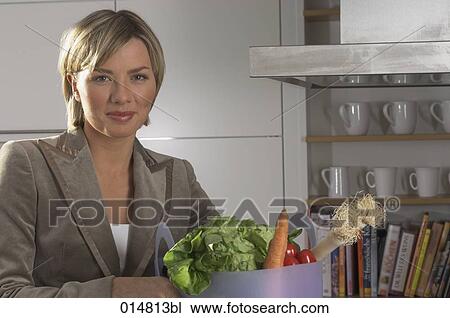 portrait of young businesswoman with shopping bag full of vegetables in kitchen View Large Photo Image Stock Image - portrait of young businesswoman with shopping bag full of vegetables in kitchen. Fotosearch