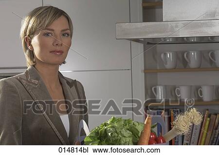 portrait of young businesswoman with shopping bag full of vegetables in kitchen View Large Photo Image Stock Image - portrait of young businesswoman with shopping bag full of vegetables in kitchen. Fotosearch