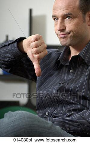 portrait of young man doing the thumbs down sign View Large Photo Image Stock Image - portrait of young man doing the thumbs down sign. Fotosearch