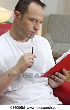 portrait of young man holding journal and pen thinking View Large Photo Image Stock Image - portrait of young man holding journal and pen thinking. Fotosearch