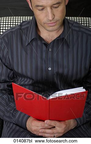 portrait of young man reading red book View Large Photo Image Stock Image - portrait of young man reading red book. Fotosearch