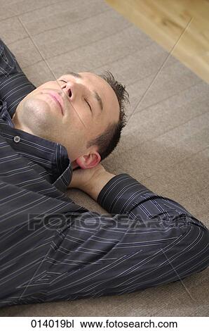 portrait of young man resting on floor with eyes closed View Large Photo Image Stock Image - portrait of young man resting on floor with eyes closed. Fotosearch