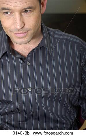 portrait of young man sitting in striped shirt View Large Photo Image Stock Image - portrait of young man sitting in striped shirt. Fotosearch