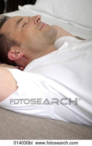 portrait of young man sleeping on bed View Large Photo Image Stock Image - portrait of young man sleeping on bed. Fotosearch