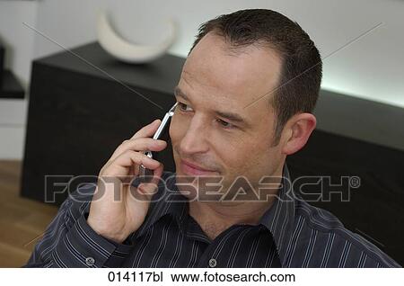 portrait of young man talking on mobile phone View Large Photo Image Stock Image - portrait of young man talking on mobile phone. Fotosearch
