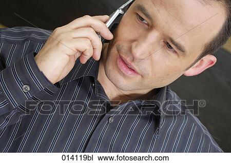 portrait of young man talking on mobile phone View Large Photo Image Stock Image - portrait of young man talking on mobile phone. Fotosearch