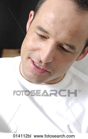 portrait of young man wearing white t-shirt View Large Photo Image Stock Image - portrait of young man wearing white t-shirt. Fotosearch