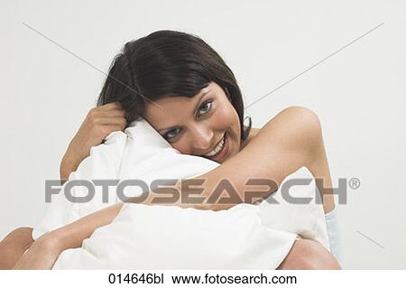 portrait of young woman cuddling white pillow View Large Photo Image Stock Image - portrait of young woman cuddling white pillow. Fotosearch