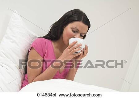 portrait of young woman drinking from white cup View Large Photo Image Stock Image - portrait of young woman drinking from white cup. Fotosearch