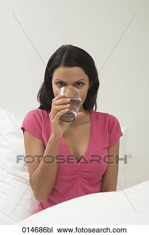 portrait of young woman drinking glass of water View Large Photo Image Stock Image - portrait of young woman drinking glass of water. Fotosearch