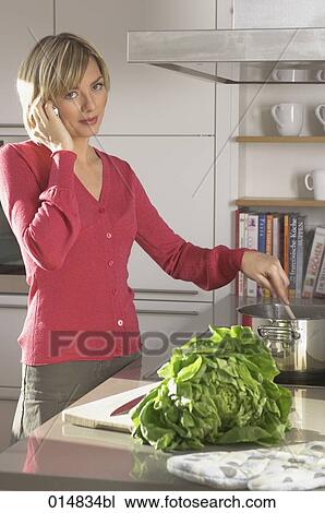 portrait of young woman in kitchen talking on mobile phone View Large Photo Image Stock Image - portrait of young woman in kitchen talking on mobile phone. Fotosearch