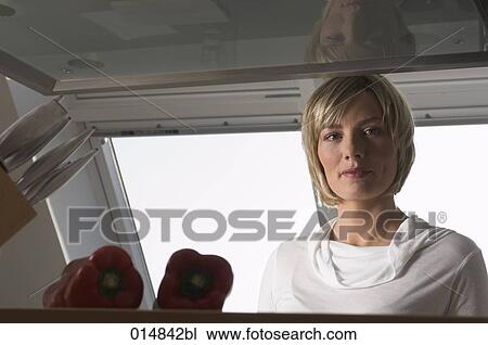 portrait of young woman in kitchen View Large Photo Image Stock Image - portrait of young woman in kitchen. Fotosearch