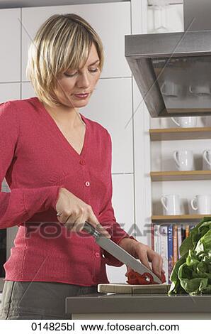 portrait of young woman preparing meal in kitchen, cutting red pepper View Large Photo Image Stock Image - portrait of young woman preparing meal in kitchen, cutting red pepper. Fotosearch