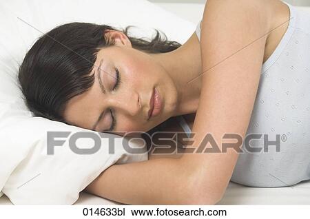 portrait of young woman sleeping in her bed View Large Photo Image Stock Image - portrait of young woman sleeping in her bed. Fotosearch
