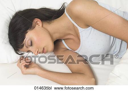 portrait of young woman sleeping in her bed View Large Photo Image Stock Image - portrait of young woman sleeping in her bed. Fotosearch