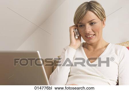 portrait of young woman with cellphone and notebook computer View Large Photo Image Stock Image - portrait of young woman with cellphone and notebook computer. Fotosearch
