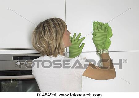 rear view of young woman cleaning cupboard View Large Photo Image Stock Image - rear view of young woman cleaning cupboard. Fotosearch