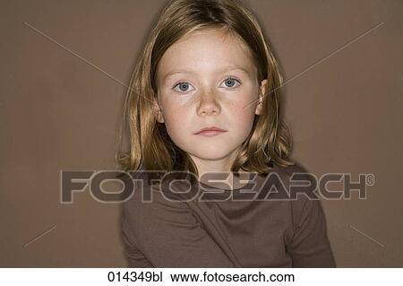 Stock Image - serious girl looking at camera. Fotosearch