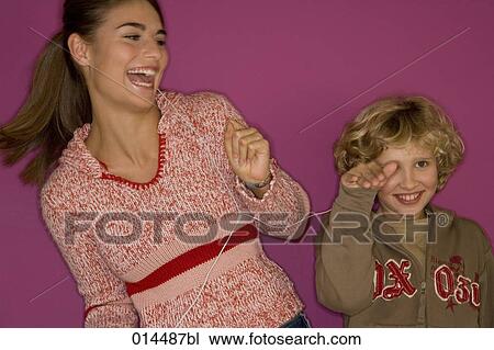 siblings sharing earphones to listen to music View Large Photo Image Stock Image - siblings sharing earphones to listen to music. Fotosearch
