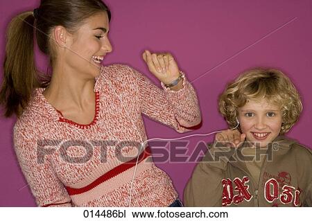 sister and brother listening to music together View Large Photo Image Stock Image - sister and brother listening to music together. Fotosearch
