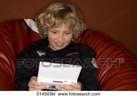 smiling boy playing computer game View Large Photo Image Stock Image - smiling boy playing computer game. Fotosearch