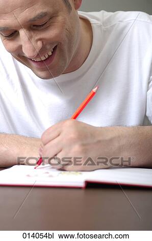 smiling man drawing in book View Large Photo Image Stock Image - smiling man drawing in book. Fotosearch