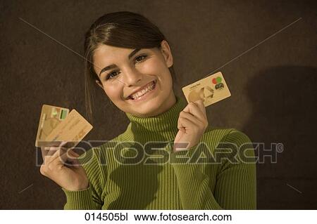 smiling teenage girl holding gold credit cards View Large Photo Image Stock Image - smiling teenage girl holding gold credit cards. Fotosearch