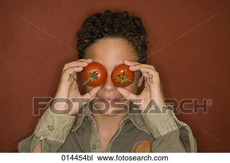 teenage boy covering eyes with tomatoes View Large Photo Image Stock Image - teenage boy covering eyes with tomatoes. Fotosearch