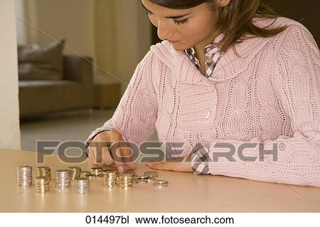 teenage girl sitting at home counting money View Large Photo Image Stock Image - teenage girl sitting at home counting money. Fotosearch