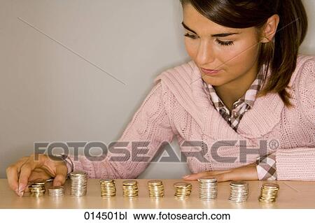 teenager making piles of coins to count her money View Large Photo Image Stock Image - teenager making piles of coins to count her money. Fotosearch
