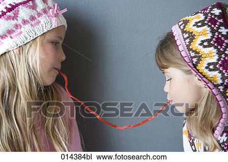 two sisters in winter clothes sharing sweets View Large Photo Image Stock Image - two sisters in winter clothes sharing sweets. Fotosearch