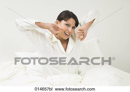 woman in white pajamas waking up in her bed in the morning View Large Photo Image Stock Image - woman in white pajamas waking up in her bed in the morning. Fotosearch