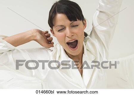 woman in white pajamas yawning in her bed in the morning View Large Photo Image Stock Image - woman in white pajamas yawning in her bed in the morning. Fotosearch