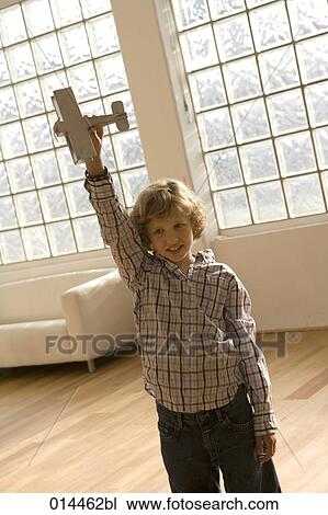 young boy playing with airplane View Large Photo Image Stock Image - young boy playing with airplane. Fotosearch
