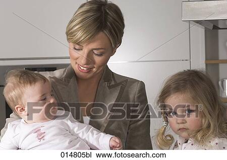 young businesswoman with her daughters one looking moody View Large Photo Image Stock Image - young businesswoman with her daughters one looking moody. Fotosearch