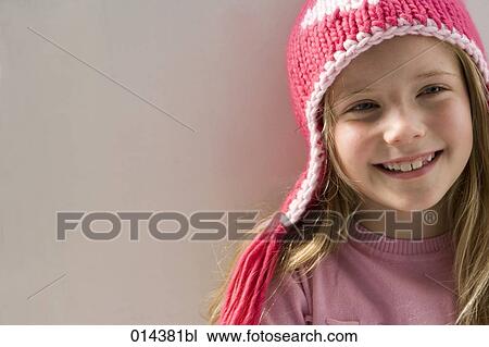 young girl with pink winter hats smiling contentedly View Large Photo Image Stock Image - young girl with pink winter hats smiling contentedly. Fotosearch